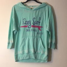 Roxy Graphic Hooded Tee Never Worn Perfect Condition Cozy Fit Green Top For Spring, Spring Green Cozy Fit Top, Pink Hoodie Tops For Loungewear, Comfy Green Cotton Top, Cozy Pink Hoodie Top, Green Stretch Top With Drawstring Hood, Cozy Pink Top With Drawstring Hood, Pink Drawstring Hood Top For Loungewear, Pink Stretch Hoodie Top