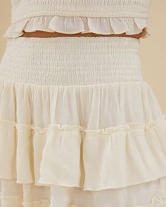 Featuring a smocked pull-on waistband, this mini skirt comes in lightweight, breathable crinkle fabric with ruffled tiers. Smocked waist Pull on style Tiered ruffle skirt Lightweight 80% Viscose 20% Nylon Hand wash in cool water. Do not bleach. Line dry in shade. Iron cool. The Smocked Ruffle Mini Skirt is styled with the Scooped Smocked Tank. Smocked Skirt, Rachel Parcell, Crinkle Fabric, Tiered Ruffle Skirt, Ruffle Mini Skirt, Ruffle Skirt, Smocking, Mini Skirt, Bleach