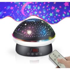 a person holding a remote control next to an alarm clock with colorful stars on it