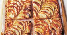 an apple tart is cut into squares on a cutting board