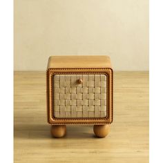 a small wooden table with a basket on it's top and one drawer in the middle