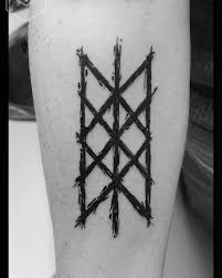 a black and white photo of a tattoo design on the leg, with barbed wire