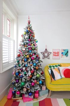 a brightly colored christmas tree in a living room