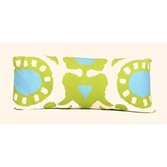 a green and blue decorative pillow on a white background with an oval design in the center