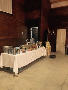 a long table with food on it in the middle of a large room filled with wooden walls