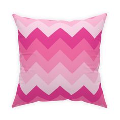 a pink and white chevroned pillow on a white background