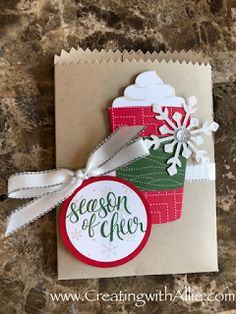 a handmade christmas card with a cupcake on it and a tag that says season of cheer