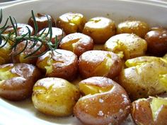 cooked potatoes with herbs in a white bowl