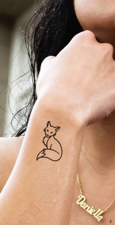 a woman with a small tattoo on her arm