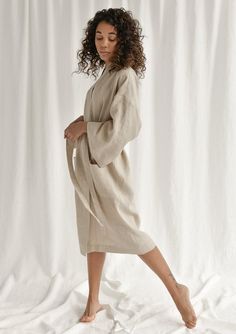 Spoil yourself with a linen bathrobe that's incredibly soft, light, and breathable. Handcrafted of premium quality European linen, this beige kimono-style bathrobe feels so good to the skin, you'll never want to take it off. The linen robe features a relaxed fit, long sleeves, an adjustable waistband, and comfy outer pockets, making it the ultimate addition to your at-home wear. The model is 175 cm (69'') tall and is wearing a bathrobe in size S/M.DETAILS- Handmade from high-quality European lin Cream Summer Robe For Loungewear, Elegant Linen Summer Robe, Elegant Summer Linen Robe, Beige Spring Loungewear Robe, Beige Long Kimono For Daywear, Beige Robe For Spring Loungewear, Summer Linen Loungewear Robe, Summer Linen Robe For Loungewear, Spring Linen Loungewear Robe