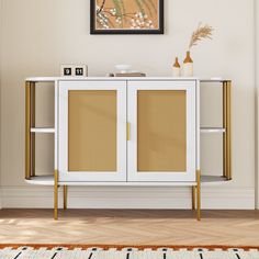 a white and gold sideboard in a living room with a painting on the wall