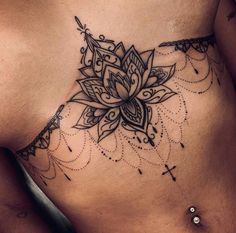 a woman's stomach with a flower tattoo on it