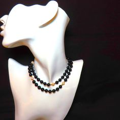 On offer is this vintage 1970's superb quality genuine Black Onyx, White Cultured Pearls and solid 14 karat yellow gold filigree Fish Hook clasp with solid 14k gold spacer beads. The large 8 mm gems glow with a very high polish which contrasts against the white of the cultured pearls which are perfectly matched and highlighted by the bright 14k gold spacer beads. In very good condition with no damage. The clasp has a safety latch and is hallmarked 14k. The length is a nice 24.5 inches. This neck Elegant Double Strand Necklace With Black Beads, Elegant Double Strand Black Bead Jewelry, Classic Black Necklace For Formal Occasions, Classic Black Round Beaded Jewelry, Formal Onyx Necklace With Round Beads, Formal Onyx Round Bead Necklaces, Classic Black Single Strand Jewelry, Elegant Single Strand Onyx Jewelry, Formal Onyx Necklace