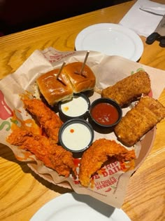 a basket filled with fried food on top of a wooden table