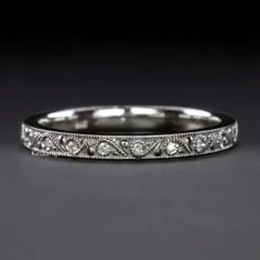 an antique style wedding band with diamonds