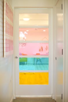 an open door leading to a brightly colored room