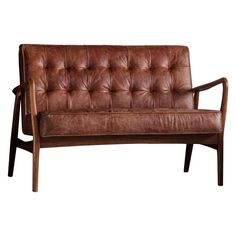 a brown leather couch sitting on top of a wooden frame