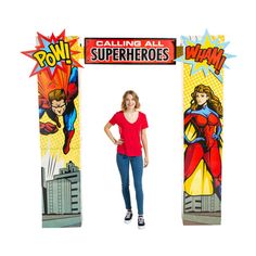 a woman standing in front of a sign that says powing all superheros