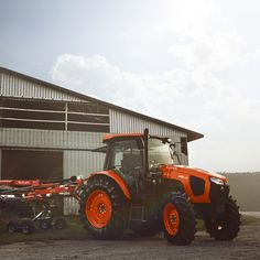 an orange tractor parked in front of a building