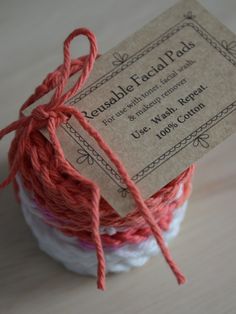 twine of red and white yarn in a jar with tag on it, sitting on a wooden surface