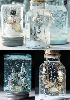 there are four different glass jars with snow in them and one is filled with christmas decorations