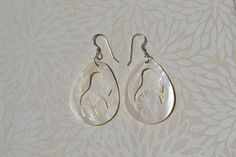 These beautiful earrings feature a hand carved white mother of pearl in a floral design. . The iridescence of the Mother of Pearl Shell l is really amazing. Depending on the light source they will radiate colors varying from whites to creamy whites . The shells are then polished to a high gloss to reveal the beauty of their natural pattern. Enjoy these lightweight beauties that are so easy to wear. these beach earrings are perfect for everyday and any occasion. DETAILS - Shell types : White Moth White Mother Of Pearl Round Earrings, Handmade White Mother Of Pearl Earrings, Handmade White Earrings In Mother Of Pearl, White Round Mother Of Pearl Earrings, Unique White Pierced Earrings, Gift Shell-shaped Mother Of Pearl Earrings, Unique White Pearl Earrings For Pierced Ears, Bohemian White Mother Of Pearl Earrings, Unique White Pearl Earrings