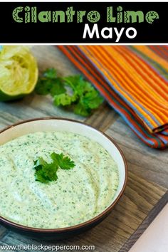 cilantro lime mayo in a bowl with fresh cilantro on the side