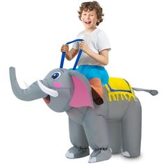 a young boy riding on the back of an inflatable toy elephant while smiling