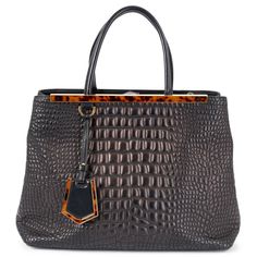 100% authentic Fendi Medium 2Jours tote bag in metallic dark brown and black smooth croco quilted Nappa leather. The design features gold-tone hardware and cognac brown tortoise top frame. Opens with a push-button. The interior is lined in black canvas with a large zipped compartment in the middle and two patch pockets against the back. Comes with a detachable shoulder-strap. Has been carried and is in excellent condition. Comes with dust bag. 2014 Fall/Winter Measurements Height 27cm (10.5in) W Fendace Tote Handbags, Wooden Bag, Granny Square Bag, Pink Clutch, Croc Leather, Black Canvas, Fendi Bags, Nappa Leather, Push Button