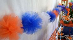 an orange, white and blue party with cupcakes