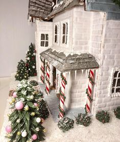 a gingerbread house decorated with candy canes and christmas decorations