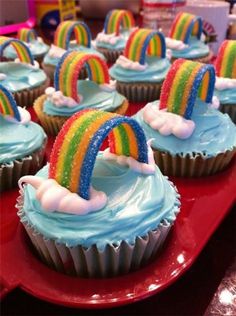 cupcakes with blue frosting and rainbow decorations