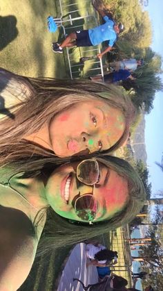 two girls with their faces painted in different colors