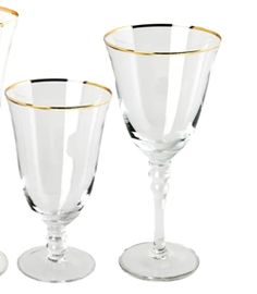 three wine goblets with gold rims are shown in three different sizes and shapes