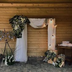 an outdoor wedding setup with flowers and greenery