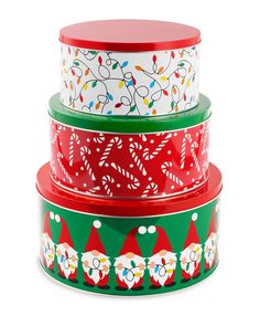 three stacking containers with christmas themed designs on the top and bottom, each decorated with candy canes