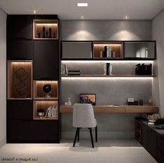 a modern home office with built - in shelving units and lighting on the wall