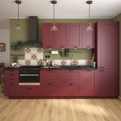 a kitchen with wooden floors and red cabinets