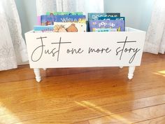 a white sign that says just one more story on it in front of some books