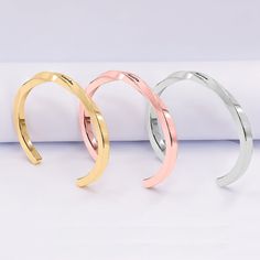 Our personalized twisted engraved stainless steel cuff bangle is a beautiful handcrafted from hammered Stainless Steel with a delicate twist style . The design is simple beautiful and elegant. This year more than ever you need the perfect gift for a birthday, your Bridesmaids or any occasion. It can be personalized with names, dates or a special message engraved on the front. It's available in silver tone, gold tone and rose gold tone. + Material - Stainless Steel.+ Weight - 22.9 g.+ Thickness - Engraved Metal Bangle As Gift, Elegant Engraved Adjustable Bangle, Engraved Metal Bangle Gift, Elegant Engraved Metal Bangle, Engraved Stainless Steel Bangle As Gift, Monogrammed Cufflinks, Leather Kits, Swarovski Heart, Name Earrings