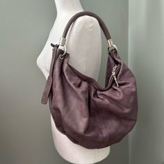 Nwot - Dimoni Mauve/Dusty Lavender Leather Hobo Handbag. Casual Versatile Style And Unique Color. Made Of 100% Soft Spanish Leather. Impeccable Navy Blue Lined Interior. Impeccable Leather With No Apparent Scuffs. Interior Has One Zip Pocket And One Slip Pocket. Silver Color Metal Hardware. Like New. Never Worn.Mase In Spain. Everyday Silver Soft Leather Bag, Everyday Silver Leather Hobo Bag, Silver Leather Hobo Bag For Everyday, Silver Hobo Bag With Silver-tone Hardware For Everyday, Everyday Silver Hobo Bag With Silver-tone Hardware, Purple Travel Bag With Silver-tone Hardware, Purple Shoulder Bag With Silver-tone Hardware For Evening, Evening Bags With Silver-tone Hardware In Purple, Silver Elegant Hobo Bag For Everyday Use