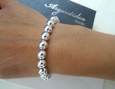 Brand: Argentidea Jewelry Instagram: https://www.instagram.com/gioielli_argentidea/ Measurement: 19.5 cm Weight: 23g. Silver colour Classic women's bracelet, in 925 silver, with smooth spheres. The spheres have a diameter of 8 mm. The bracelet features an oval lobster clasp. The bracelet is the natural color of silver, manually polished to a shiny finish. A completely handcrafted jewel, conceived, designed, produced and finished entirely by hand by master goldsmiths in our laboratory in Arezzo i Logo Jewelry, Handcrafted Silver Jewelry, Jewelry Instagram, Ball Bracelet, Silver Colour, Carrier Bag, Chain Link Bracelet, Womens Bracelets, Natural Color