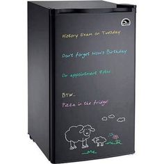 a black refrigerator with writing on the door and sheep drawn on it's side