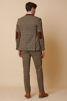 Inspired by old age country wear, the DX7 suit remains an ever so popular style, reminiscent of the 18th century. It is ideal for Autumn/Winter with its earthy colour palette and heavy fabric. A touch of modernism is added with a velvet contrast collar, elbow pads and pocket trims, nudging it back into the 21st century. Perfect for a rustic countryside wedding. Mix-and-match the waistcoat to differentiate from the groomsmen and match your accessories with the bridesmaid dresses. Looking for a pl Tailored Brown Tweed Jacket With Welt Pockets, Tailored Tweed Three-piece Suit For Winter, Winter Tailored Tweed Three-piece Suit, Tailored Three-piece Suit With Welt Pockets For Fall, Winter Tweed Three-piece Suit, Brown Tweed Jacket With Suit Collar, Brown Wool Suits For Winter, Fitted Brown Suits For Fall, Brown Wool Suit For Winter