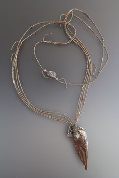 This beautiful long necklace has a "vintage" brass wing with a sterling silver bee perched on it. The beautiful and delicate strands are antique French brass from old evening purses from the early 1900's.  The strands are accented with faceted pyrite an copper. the closure is an antique sterling silver button. This piece can be worn long or short. My work is guaranteed against breakage caused by myself due to the nature of strung beads. This happens rarely! If you catch it, and a strand breaks, Elegant Wing-shaped Yellow Gold Necklace, A Wing, Strung Beads, Evening Purse, Silver Buttons, A Prayer, Vintage Brass, Long Necklace, French Antiques