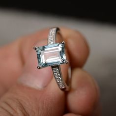 This is a gorgeous handmade creation. Its beauty is its simplicity & Elegance. The 6*8mm emerald cut shape faceted aquamarine is crafted in solid sterling silver and with rhodium plated. All item is sent in a beautiful gift box You can realize more lovely stuff clicking the link https://www.etsy.com/shop/knightjewelry?refshopsection_shophome_leftnav Please leave the correct address and you phone number for delivering successfully. Luxury Square Cut May Birthstone Ring, Luxury Emerald-cut Birthstone Promise Ring, Octagon Blue Topaz Ring For Anniversary, Fine Jewelry Blue Topaz Octagon Ring, Octagon Blue Topaz Rings Fine Jewelry, Fine Jewelry Aquamarine Baguette Cut Ring, Fine Jewelry Octagon Topaz Ring With Accent Stones, Fine Jewelry Blue Topaz Rectangular Rings, Octagonal Blue Topaz Ring With Prong Setting