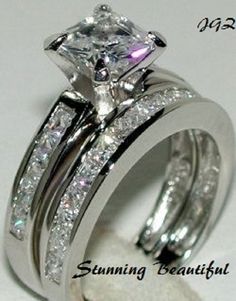 an engagement ring set with a princess cut diamond in the center and matching wedding bands