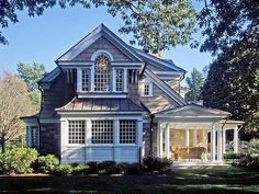 a large gray house with white trim and windows