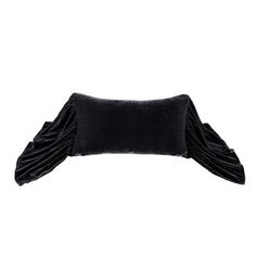 a black velvet pillow with ruffles on the top and bottom, against a white background