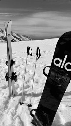 two snowboards and skis in the snow